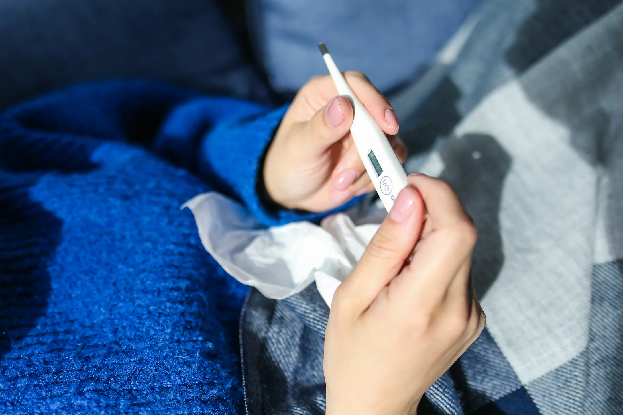 Person holding thermometer