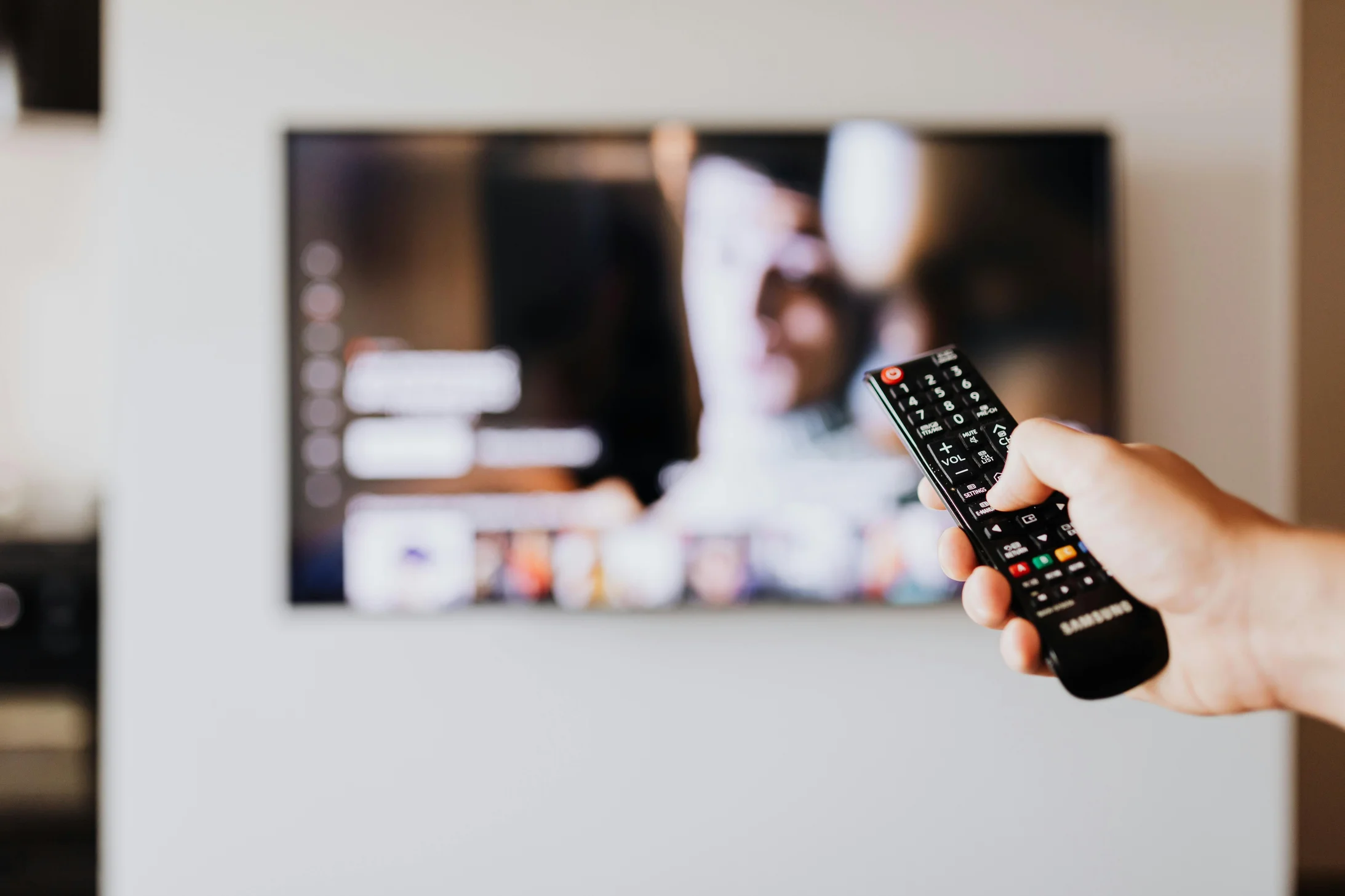 Person pressing the button of a remote control