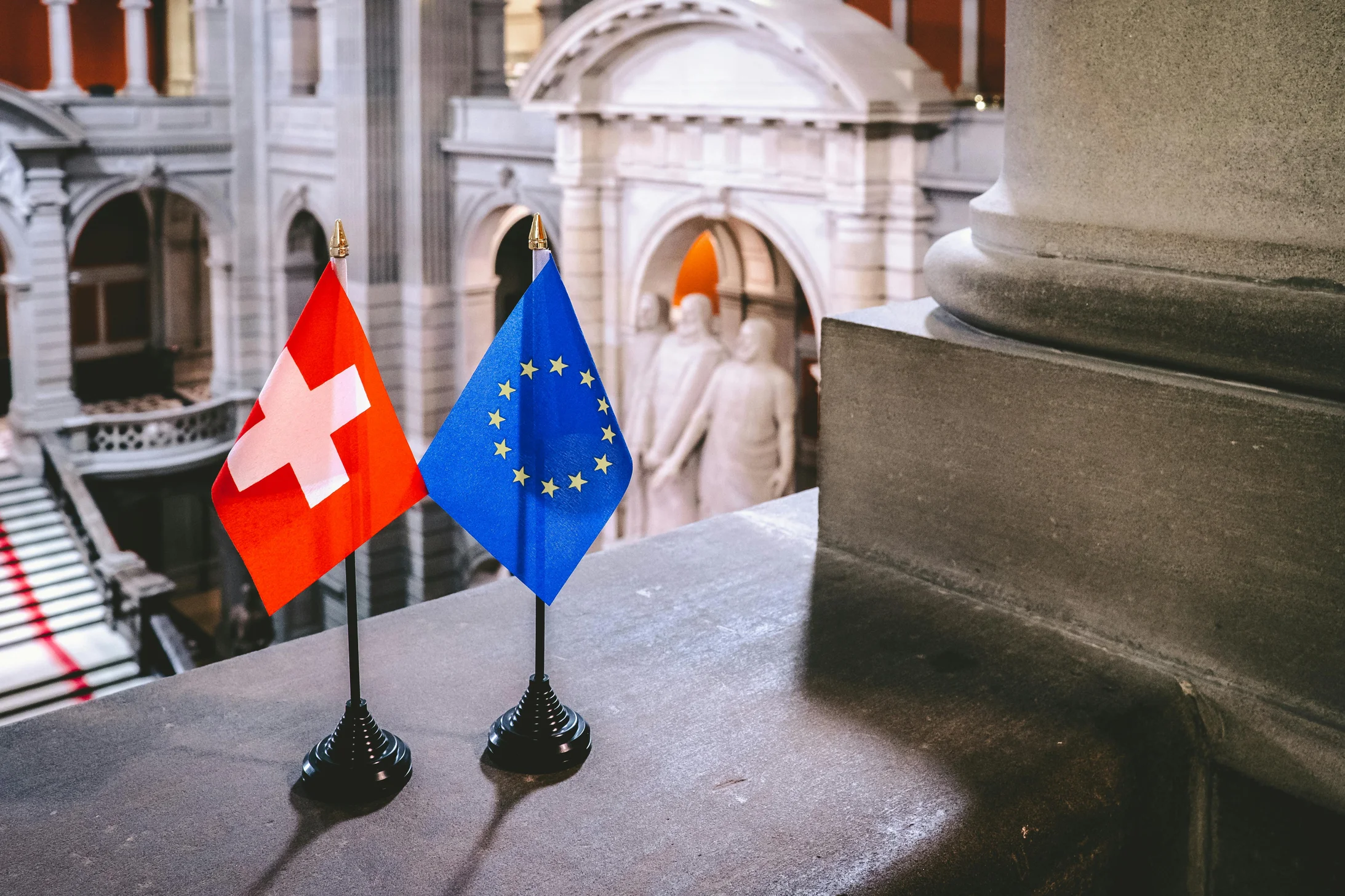 Switzerland and europian flags on black stands