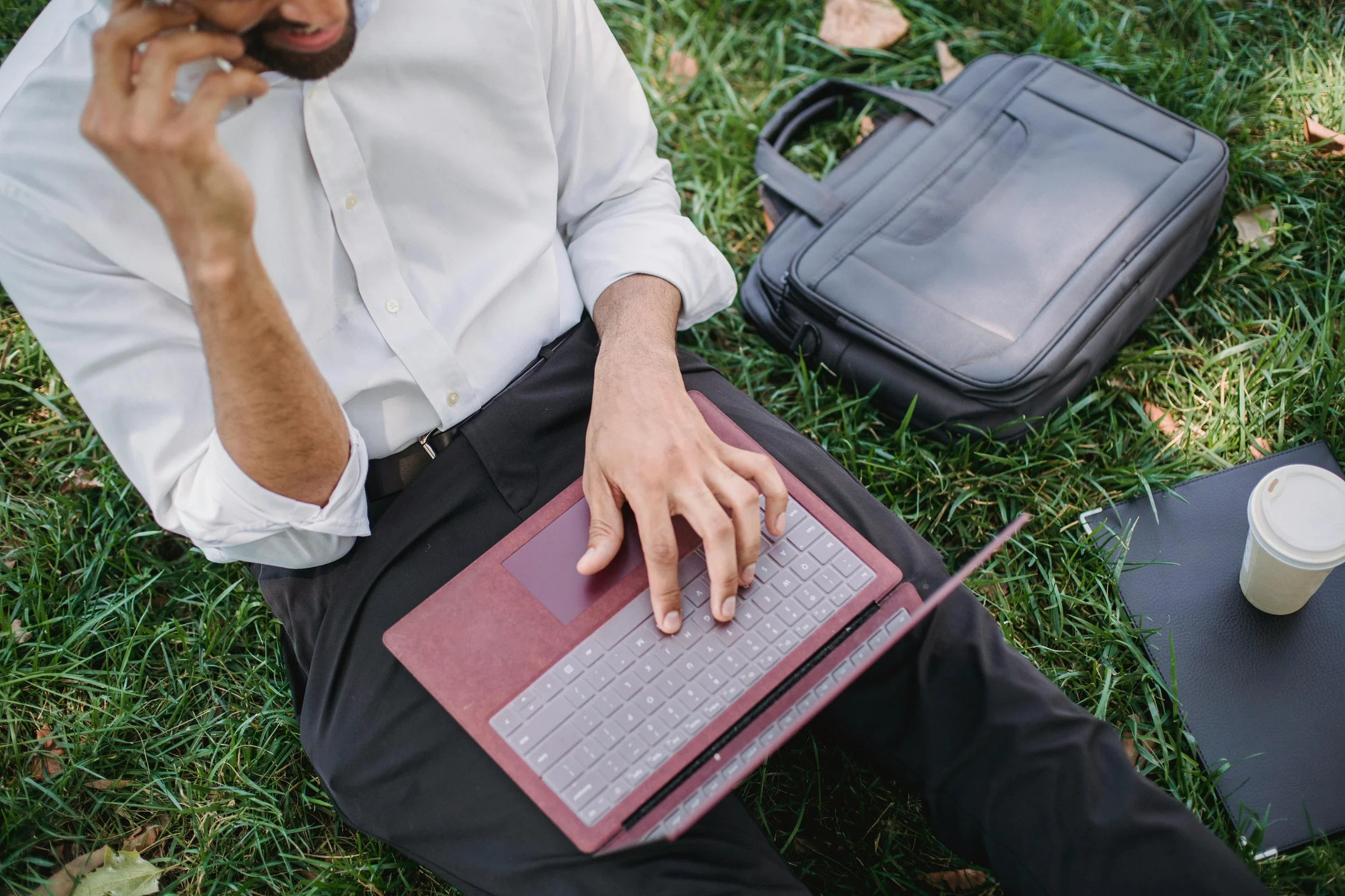 Businessman working with laptop in park